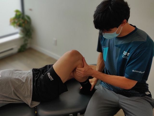 Image of modern Vancouver chiropractor assessing a client's knee