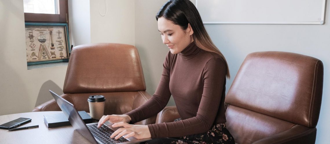 Woman working on laptop with good sitting posture